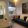Photo 2: Communal lounge with sofas and 49" TV