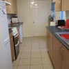 Photo 4: Long galley kitchen with appliances