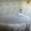 Photo 2: Private bathroom, corner bath with shower