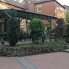Photo 9: There is a covered over patio area with tables and chairs