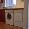 Photo 6: kitchen has top of the range Miele washing machine and dryer