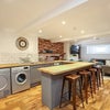 Photo 4: Fully equipped kitchen with 2 washing machines