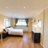 Photo 2: The other side of the room showing a chest of drawers, double bed and two bedside tables.