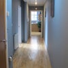 Photo 3: View from front door area of hallway of apartment