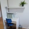 Photo 2: Small desk and shelves with plugs at the back of the desk