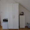 Photo 2: Microwave, fridge, kettle and cupboards