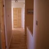 Photo 7: Hallway with laundry cupboard at the end