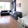 Photo 3: Spacious living room with massive sofa and more dining space