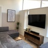 Photo 8: Living room with 48ins TV and giant sofa for chilling!