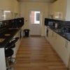Photo 5: Large kitchen with two sinks, two ovens. Separate utility room with clothes dryer and washing machin