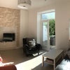 Photo 4: Shared living room with outside deck
