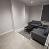 Photo 3: communa living area with wall mounted Smart TV
