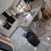 Photo 5: Kitchen and breakfast bar (excuse the rubbish bags) 