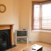 Photo 4: Spacious Lounge with High Ceilings & Ornate Fireplace