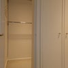 Photo 7: Walk-in wardrobe with rails, shelfand tall chest of drawers