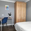 Photo 2: Your room - corner desk and chair, wardrobe, and under-bed storage