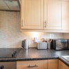 Photo 5: Kitchen with washing machine etc