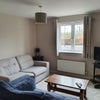 Photo 5: Living room.  Bit of an old photo.  We have new sofas now and a tv stand and a bigger tv :)