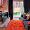 Photo 3: Includes NetFlix! The "snug" area opens onto the sunny garden.