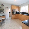 Photo 5: Kitchen with additional seating plus utility room
