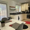 Photo 4: Kitchen with integrated washing machine, fridge, freezer and leading into the garden