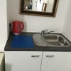 Photo 4: Sink kettle and storage cupboard in room 