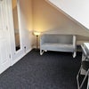 Photo 4: Room has sofa, desk, chair and mirror