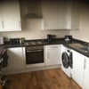 Photo 9: Kitchen with tumble dryer, washing machine, mico-wave, cooker, and own fridge.