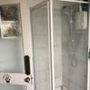 Photo 2: Bathroom with electric shower 
