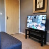 Photo 7: Lounge / TV area with HD Sony smart TV and 2 seater sofa