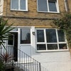 Photo 8: Back garden. Small window top left is the room available