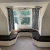 Photo 2: Sitting area with storage underneath 