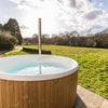 Photo 1: Soak and unwind in our log-fired Skarsgard hot tub