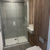 Photo 1: en-suite bathroom with shower & storage above toilet (also floor heating which is great)