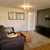 Photo 5: Living room, has 2  big sofas and a large tv on wall