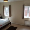 Photo 2: First bedroom - dark wood overlooking back garden