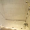 Photo 9: Bath with shower of the larger bathroom
