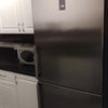 Photo 7: Kitchen includes large fridge freezer and microwave.
