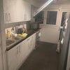 Photo 5: New kitchen! Left the wrapping on new cupboards to preserve