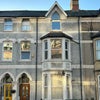Photo 6: Front of House (Bedroom shown on First Floor)