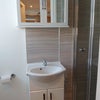 Photo 6: Vanity basin, toilet, shower & cupboard. Fan and window