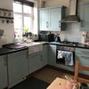 Photo 4: Kitchen with blue cupboards, oven, sink etc 