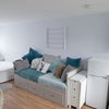 Photo 2: Living area and sleeping area/bed