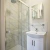 Photo 5: Private en-suite bathroom with high pressure shower, basin, under cabinet storage, toilet