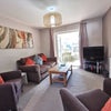 Photo 3: Modern sitting room with Next sofa and chairs, and large screen TV.