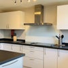 Photo 2: Kitchen: Showing Double Fan Oven, Two Electric Hobs, Storage Cupboards.