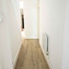 Photo 5: Hallway with storage under stairs and at end of  hallway