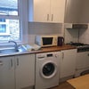 Photo 6: Kitchen with washing machine and fridge