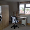 Photo 4: double wardrobe, desk, and office chair with a view of North London.