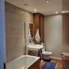 Photo 4: Shared bathroom (bath has shower attachment).